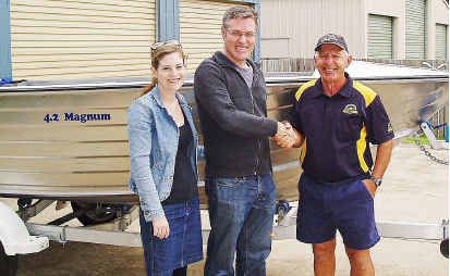 Commander Jim George (right) at the official handover of the boat raffle prize to winner Arron Dillaway and his wife Amie. Commander Jim George (right) at the official handover of the boat raffle prize to winner Arron Dillaway and his wife Amie.